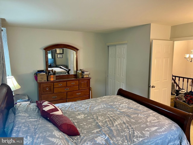 bedroom with a closet and a chandelier