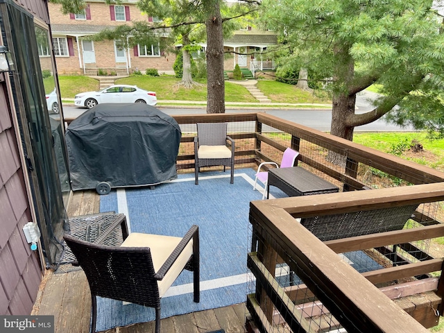 wooden terrace with a grill