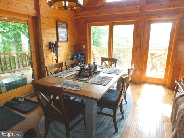 158 Hideaway Ln, Upper Tract, WV 26866 - dining area featuring wood walls, light wood-style flooring, and a chandelier