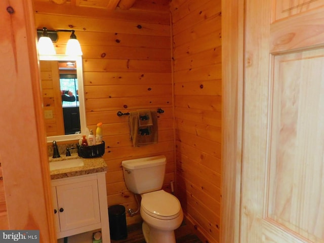 158 Hideaway Ln, Upper Tract, WV 26866 - bathroom featuring wooden walls, toilet, and vanity