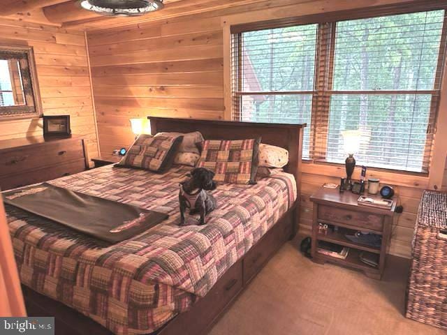 158 Hideaway Ln, Upper Tract, WV 26866 - bedroom featuring multiple windows, wooden walls, and carpet flooring