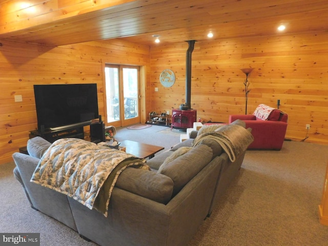 158 Hideaway Ln, Upper Tract, WV 26866 - carpeted living area featuring a wood stove, wood walls, and recessed lighting