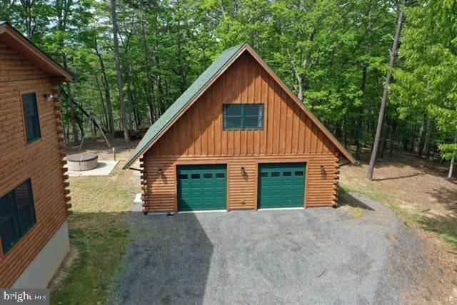158 Hideaway Ln, Upper Tract, WV 26866 - garage featuring a garage and a forest view