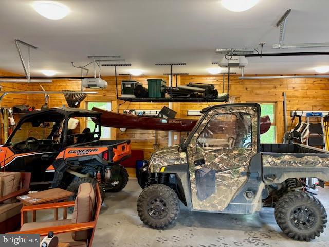 158 Hideaway Ln, Upper Tract, WV 26866 - garage with wooden walls and a garage door opener