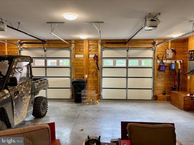 158 Hideaway Ln, Upper Tract, WV 26866 - garage featuring wood walls and a garage door opener