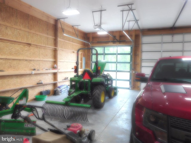 158 Hideaway Ln, Upper Tract, WV 26866 - garage featuring a garage door opener and wood walls