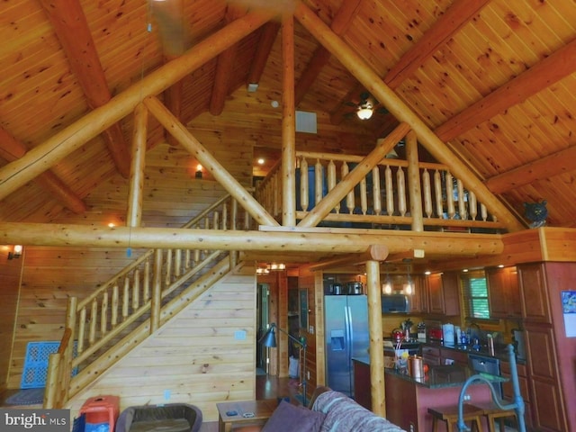 158 Hideaway Ln, Upper Tract, WV 26866 - living area featuring high vaulted ceiling, beamed ceiling, and stairway
