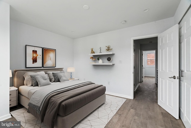 bedroom with light wood finished floors and baseboards