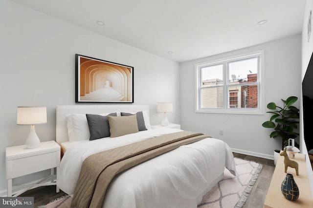 bedroom with wood finished floors and baseboards