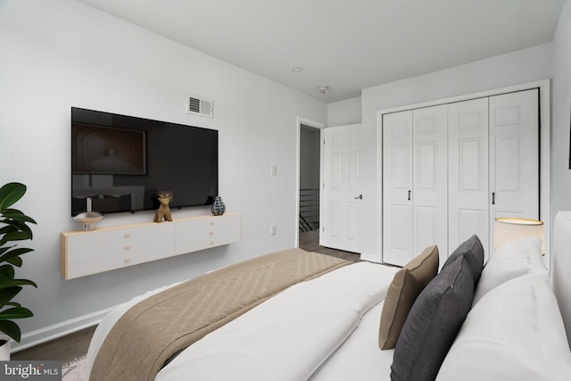 bedroom featuring baseboards, a closet, and wood finished floors