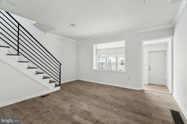 unfurnished living room featuring ornamental molding, wood finished floors, stairway, baseboards, and recessed lighting