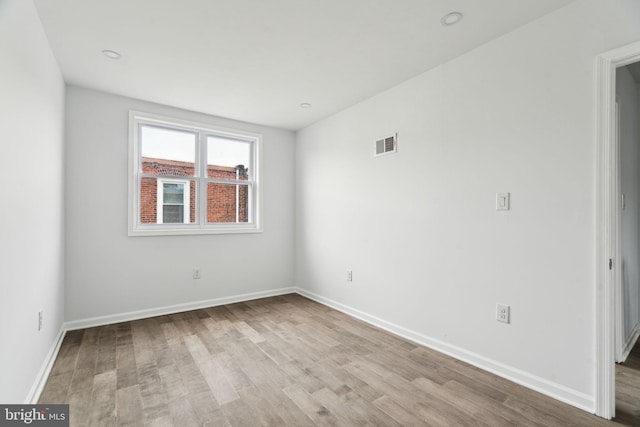 empty room featuring wood finished floors and baseboards