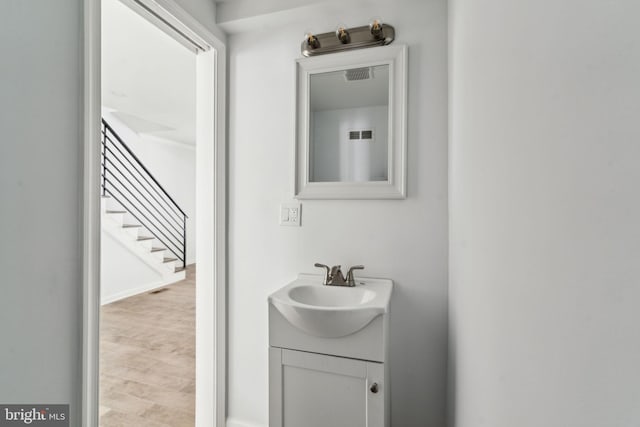 bathroom with vanity and wood finished floors