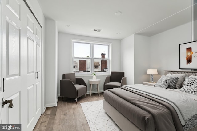 bedroom with baseboards and light wood-style floors
