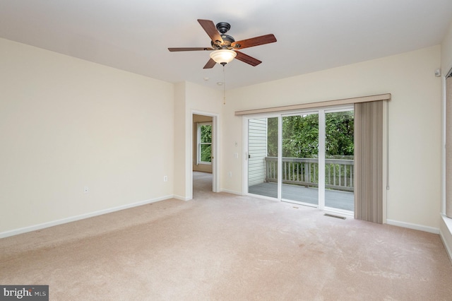 spare room featuring carpet, baseboards, and a ceiling fan