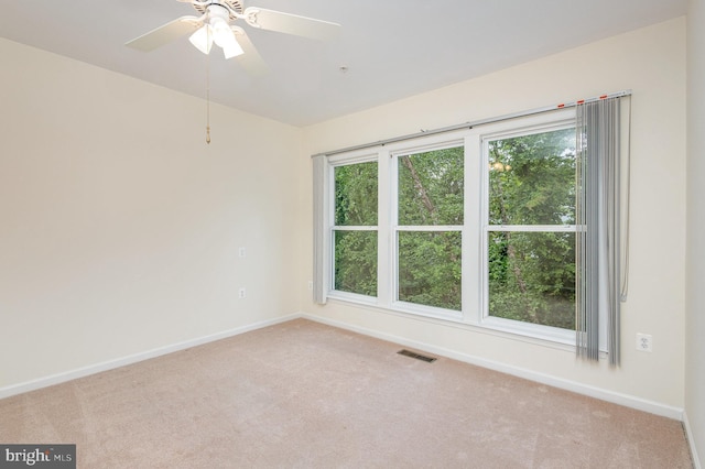 unfurnished room with carpet flooring, baseboards, and ceiling fan