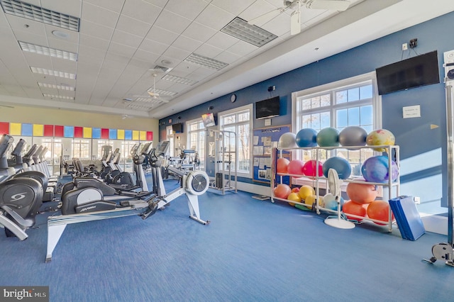 exercise room with a paneled ceiling