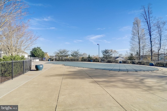 view of swimming pool featuring fence