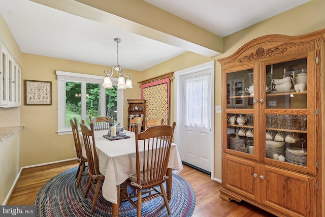 3919 30th St N, Arlington, VA 22207 - dining space featuring a chandelier, light wood finished floors, and baseboards