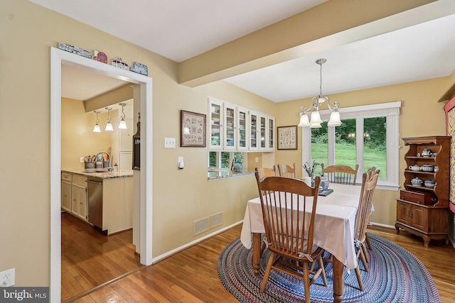 3919 30th St N, Arlington, VA 22207 - dining space with wood finished floors, healthy amount of natural light, and a chandelier