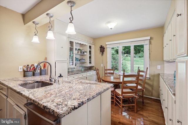 3919 30th St N, Arlington, VA 22207 - kitchen featuring a sink, dishwasher, dark wood finished floors, open shelves, and light stone countertops