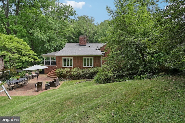 3919 30th St N, Arlington, VA 22207 - rear view of house featuring a patio, a lawn, brick siding, a chimney, and a shingled roof