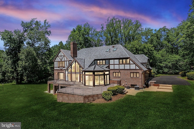 6723 Georgetown Pike, Mclean, VA 22101 - back of house featuring a lawn, a chimney, brick siding, and a patio area