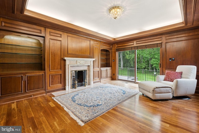 6723 Georgetown Pike, Mclean, VA 22101 - living area featuring ornamental molding, wood walls, a premium fireplace, built in features, and dark wood-style floors
