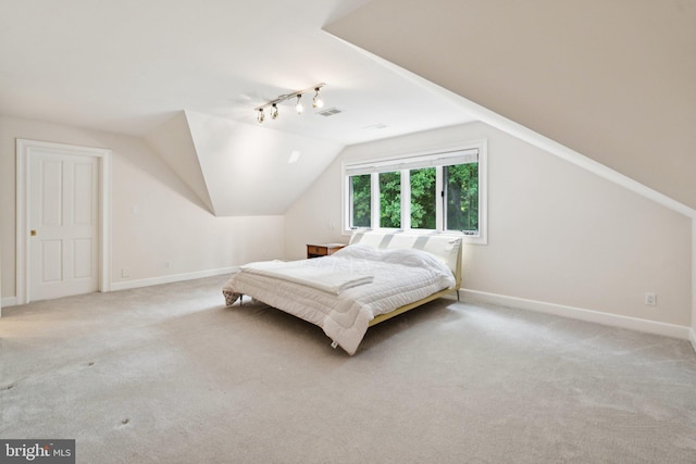 6723 Georgetown Pike, Mclean, VA 22101 - bedroom featuring light carpet, rail lighting, lofted ceiling, and baseboards