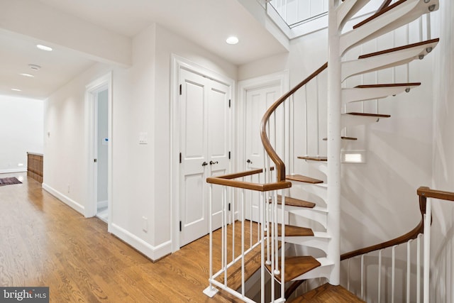 6723 Georgetown Pike, Mclean, VA 22101 - stairway with baseboards, wood finished floors, recessed lighting, and a skylight