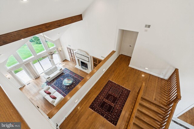 6723 Georgetown Pike, Mclean, VA 22101 - living area featuring high vaulted ceiling, wood finished floors, baseboards, and beamed ceiling