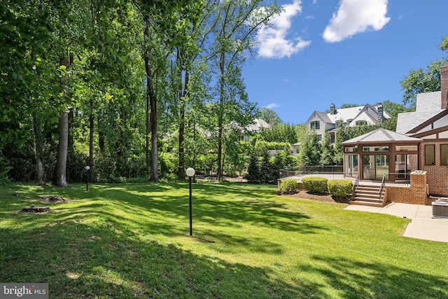 6723 Georgetown Pike, Mclean, VA 22101 - view of grassy yard with a fire pit