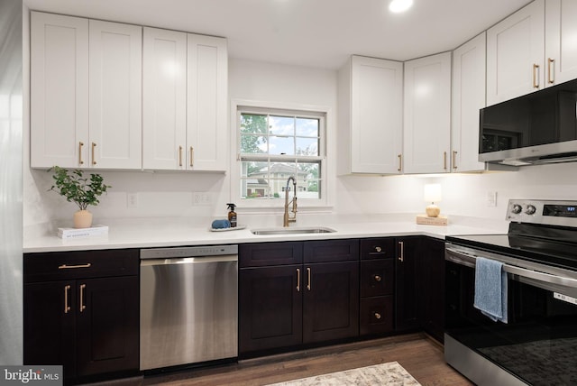 5632 Maxine Ct, Alexandria, VA 22310 - kitchen featuring stainless steel appliances, a sink, wood finished floors, white cabinetry, and dark cabinets