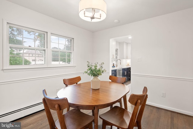 5632 Maxine Ct, Alexandria, VA 22310 - dining area featuring a baseboard heating unit, wood finished floors, and baseboards
