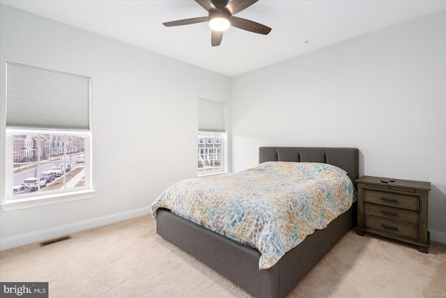 carpeted bedroom featuring baseboards and ceiling fan