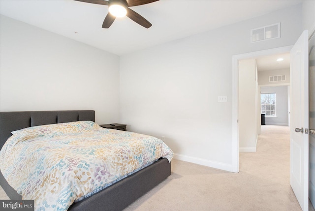 bedroom with light carpet, baseboards, and ceiling fan