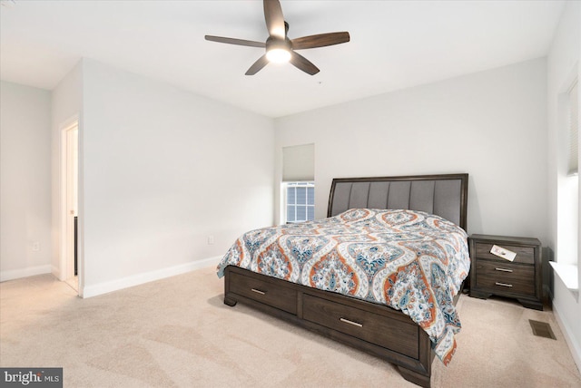 bedroom featuring light carpet, baseboards, and ceiling fan
