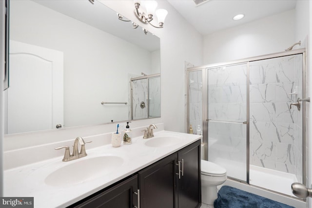 full bath featuring a marble finish shower, toilet, and double vanity