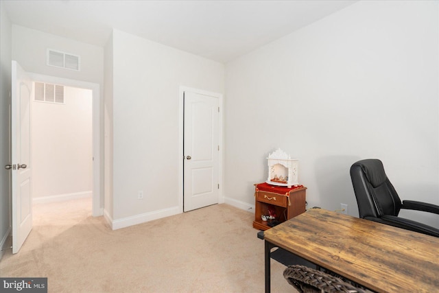 home office with light colored carpet and baseboards