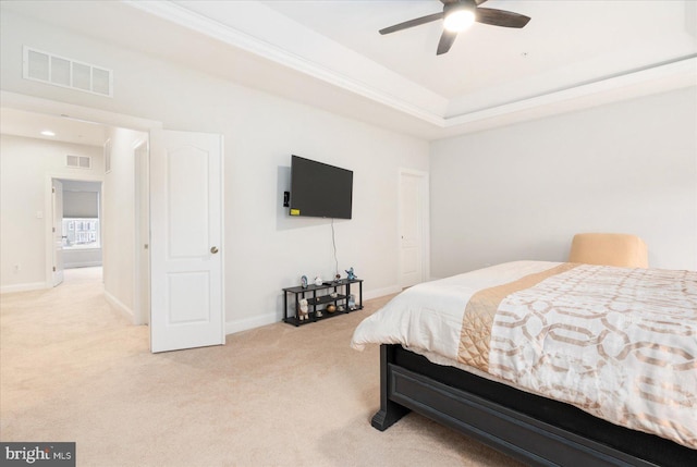 bedroom featuring light colored carpet, baseboards, and crown molding