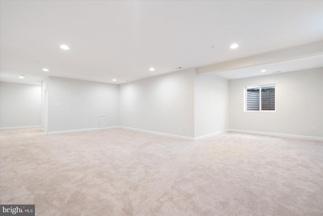 finished basement with recessed lighting, light carpet, and baseboards