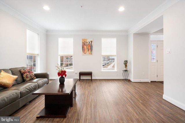 living room featuring ornamental molding, wood finished floors, baseboards, and recessed lighting