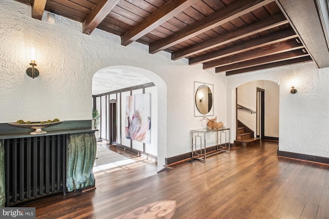302 Ellsworth Dr, Silver Spring, MD 20910 - hall with a textured wall, arched walkways, wooden ceiling with exposed beams, wood finished floors, and stairway