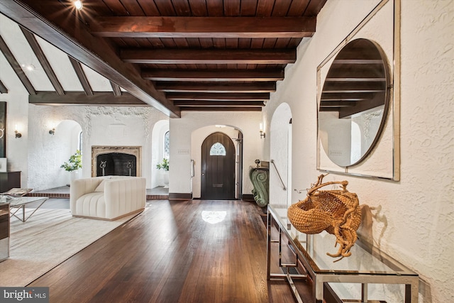 302 Ellsworth Dr, Silver Spring, MD 20910 - foyer with arched walkways, wood ceiling with exposed beams, a textured wall, and wood finished floors
