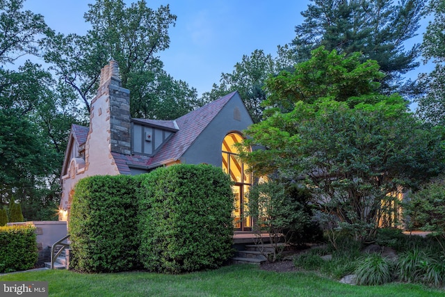302 Ellsworth Dr, Silver Spring, MD 20910 - view of front of house with stucco siding, a chimney, and a high end roof