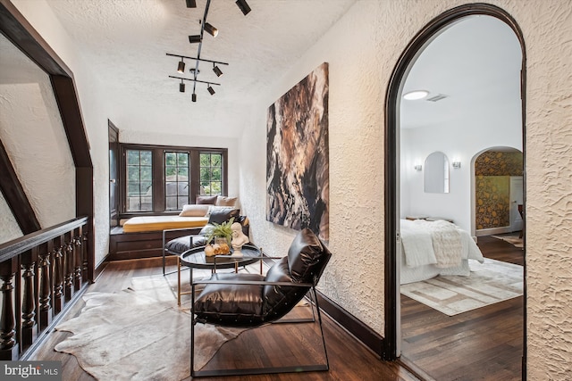 302 Ellsworth Dr, Silver Spring, MD 20910 - interior space with arched walkways, hardwood / wood-style flooring, a textured wall, baseboards, and a textured ceiling