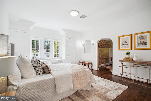 302 Ellsworth Dr, Silver Spring, MD 20910 - bedroom featuring arched walkways, wood finished floors, and baseboards