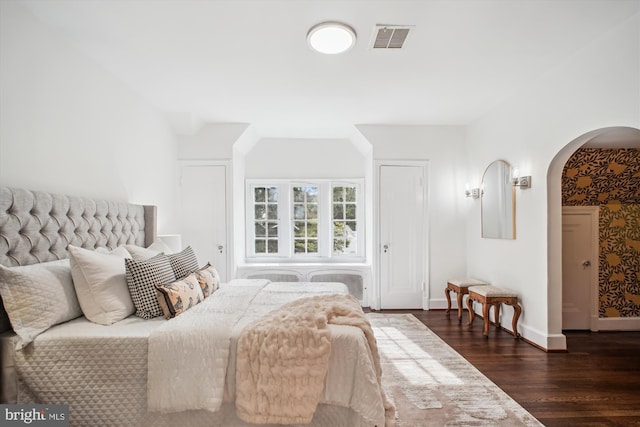 302 Ellsworth Dr, Silver Spring, MD 20910 - bedroom with arched walkways, dark wood-type flooring, and baseboards