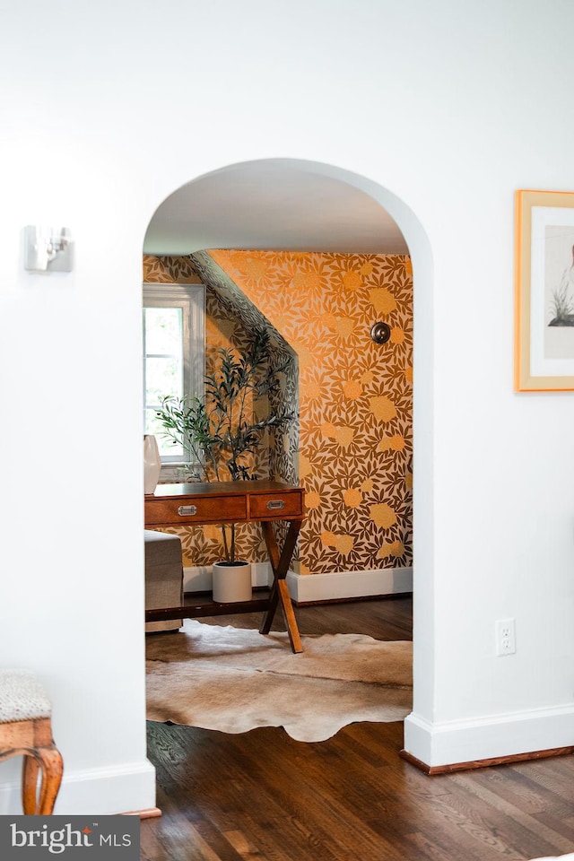 302 Ellsworth Dr, Silver Spring, MD 20910 - hallway with arched walkways, wallpapered walls, baseboards, and wood finished floors