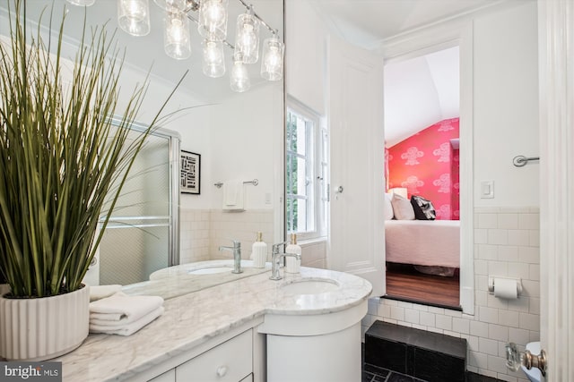 302 Ellsworth Dr, Silver Spring, MD 20910 - bathroom featuring tile walls, ensuite bath, vanity, wainscoting, and lofted ceiling